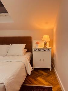 a bedroom with a bed and a lamp on a night stand at American Dream Villa in Łazory +74 photos