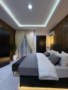 a large bedroom with a large bed and a window at JKB APARTMENt in Lekki +6 photos