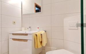 a white bathroom with a sink and a toilet at Pension An der Kamske - DZ 1 in Lübbenau