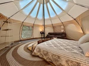 a bedroom with a bed in a tent at Gite tente LOTUS in Montesquieu