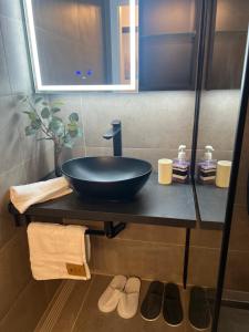a bathroom with a black sink on a counter at Friendly Space Apartment in Graz