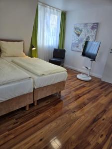 a bedroom with a bed and a flat screen tv at Loft Linda in Sylt