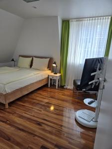 a bedroom with a bed and a desk with a computer at Loft Linda in Sylt