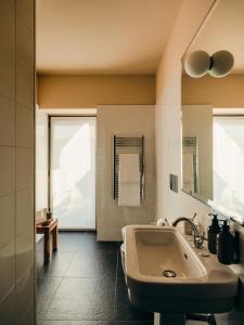 a bathroom with a sink and a large window at Aethos Hotel Milan in Milan +105 photos