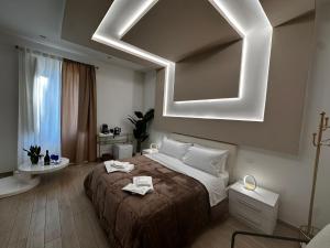 a bedroom with a large bed and a mirror at Centrale Suites in Brindisi