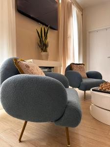 a living room with two chairs and a tv at Centrale Suites in Brindisi