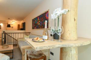a room with a table with a bottle of wine and glasses at MGH Luxury- Romantic SPA & Relax in Poiano