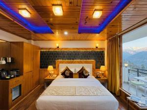 a bedroom with a bed and a view of a mountain at The Hamilton Valley View, Koti - A Beautiful Resort in Cloud's in Shimla +20 photos