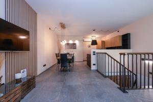a living room and dining room with a dining table at MGH Luxury- Romantic SPA & Relax in Poiano