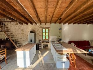 a kitchen with a wooden ceiling and a kitchen island at Authentic house, absolutely quiet in Coust