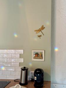 a butterfly clock on the wall of a kitchen at Authentic house, absolutely quiet in Coust