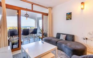 a living room with a couch and a table at Diani Beachfront by Bstan in Diani Beach