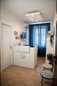 a room with a white counter and two chairs at B&B Sikelia Suite in Agrigento