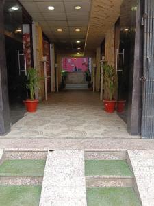 a hallway with potted plants in a building at Hotel welcome inn in Patna