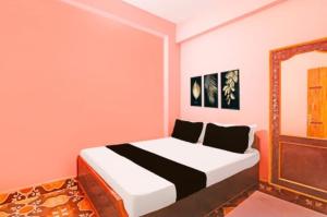 a bedroom with a bed and a mirror at Hotel welcome inn in Patna