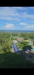 an aerial view of a resort with a pool and palm trees at Diani Beachfront by Bstan in Diani Beach