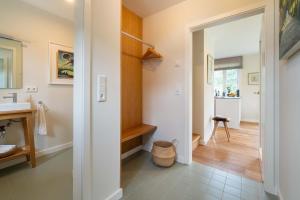 a bathroom with a sink and a mirror at Haus an der Koppel in Borgsum +34 photos