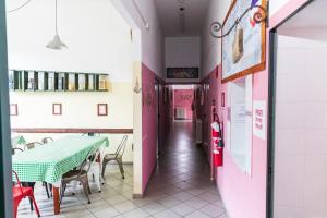 a corridor of a restaurant with a table and chairs at Ostello Tramonti in Biassa +14 photos