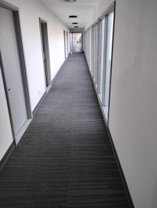 a long hallway in an office building with windows at Maplehurst Motel in Tunkhannock