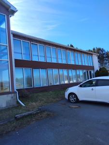 a white car parked in front of a building at Maplehurst Motel in Tunkhannock