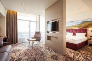a hotel room with a bed and a tv at Lielupe Hotel SPA & Conferences by Semarah in Jūrmala
