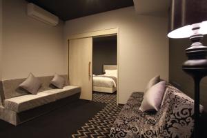 Postel nebo postele na pokoji v ubytování Centurion Hotel Grand Kobe Station