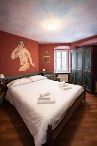 a bedroom with a large bed with a painting on the wall at Hotel Portacavana in Trieste