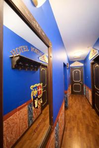 a hallway of a hotel room with a blue wall at Hotel Portacavana in Trieste