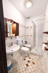 a bathroom with a sink and a toilet and a shower at Hotel Portacavana in Trieste