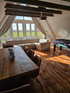 a living room with a table and a couch at Loft Linda in Sylt