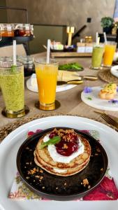 a table with a plate of food and two drinks at Bed en breakfast Suite 8 in Langenboom