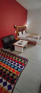 a living room with two beds and a rug at Woodward 2 by 4 Wildflower in Kasol
