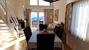 a dining room with a table and chairs and a couch at Ferienwohnung Caluna in Lenz