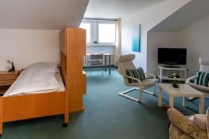 a bedroom with a bunk bed and a living room at Bergkloster Bestwig in Bestwig