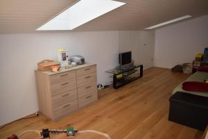 a room with a bedroom with a dresser and a tv at Ferienwohnung Caluna in Lenz