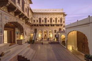 a large building with a staircase in a courtyard at Gulab Haveli - IHCL SeleQtions, Mandawa in Mandāwa