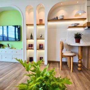 a dining room with a table and a chair at Maison de Ecopark - Onsen & Spa in Kim Quan