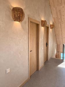 a hallway with two lights and a door at Liedaga 24 in Tūja