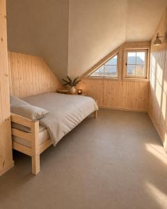 a bedroom with a bed and a window at Liedaga 24 in Tūja +5 photos