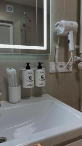 a bathroom with a white sink and a mirror at Gonta house in Skhidnitsa