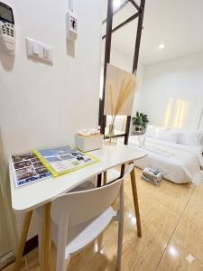 a white desk with a mirror and a chair in a room at Similan Mondo Resort & Camping in Phang-nga