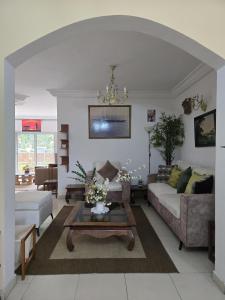 a living room with a couch and a table at Providence Guesthouse and Catering Services in Abidjan