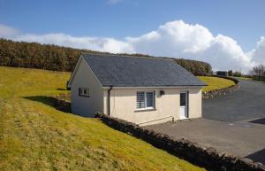 a small house on the side of a road at Skeabost View Chalet in Portree