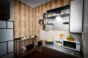 a kitchen with a counter with a microwave and a table at Dimora Nicotera in Lamezia Terme
