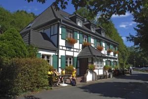 a large house with a large window on the side of the house at Wißkirchen Hotel & Restaurant in Odenthal