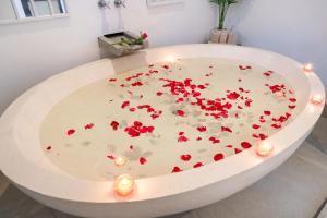 a white bath tub filled with red hearts at Nivara Pool Villa - Rawai in Rawai Beach +62 photos