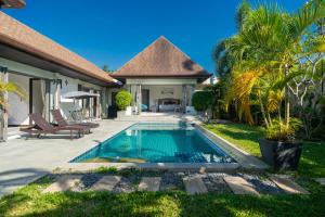 a swimming pool in the backyard of a villa at Nivara Pool Villa - Rawai in Rawai Beach