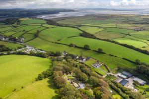 an aerial view of a green field with houses at Pods @ Broadway in Laugharne +5 photos