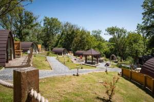 a garden with a playground and a gazebo at Pods @ Broadway in Laugharne