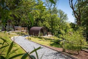 a small cabin in the middle of a garden at Pods @ Broadway in Laugharne